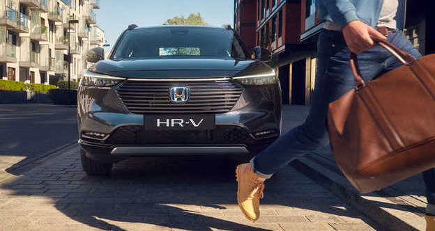 Front view of a Honda HR-V with a person walking by.