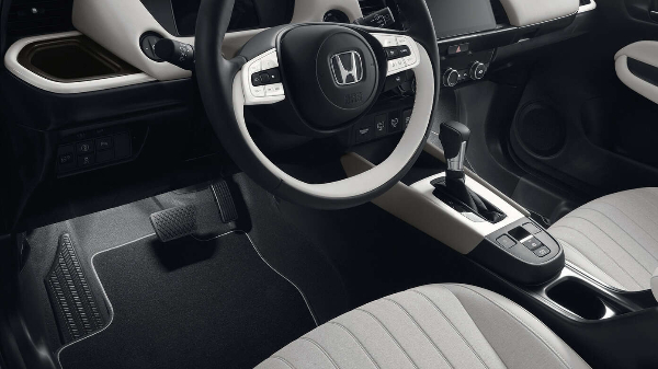 Interior view of a Honda car showing the steering wheel and gear shift.